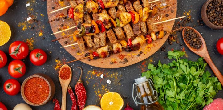 top-half-view-grilled-chicken-skewers-wooden-board-other-stuffs-table